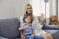 Online communication. Mother and her son talking to family from home. Parent and child looking at camera and waving Royalty Free Stock Photo