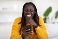 Online Communication. Portrait Of Cheerful African American Guy Using Smartphone At Home Royalty Free Stock Photo