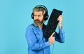 Online Cyber e-Sport Internet. gamer playing computer game. Digital Music Creation. bearded man headphones and keyboard