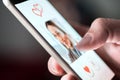 Online dating app in smartphone. Man looking at photo of beautiful woman. Royalty Free Stock Photo