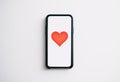 Online dating concept. Smartphone with red heart on the screen Royalty Free Stock Photo