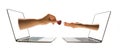 online dating concept two hands stick out of laptop screen