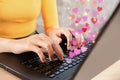 Online dating concept with woman hand chatting on computer hand typing on keyboard with heart shape Royalty Free Stock Photo