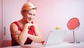 Online dating. Young woman in red dress having online date on Valentines day