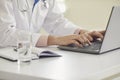 Online doctor call concept. Online doctor typing message conference video chat call webcam using laptop gadget in clinic