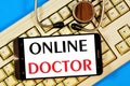 Online doctor-text inscription in a smartphone on the computer keyboard.