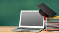 Online education. Distance learning at home. Laptop and stack of books with graduate hat Royalty Free Stock Photo