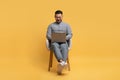 Online Education. Happy Young Asian Man Using Laptop While Sitting In Chair Royalty Free Stock Photo