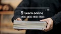 Online Learning Platform Interface with Book in Hand Royalty Free Stock Photo