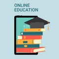 Online education. Online course concept, home school. Social distance concept. Stack of books, graduation hat and tablet Royalty Free Stock Photo