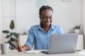 Online Education. Young Black Female Student Using Laptop At Home, Taking Notes Royalty Free Stock Photo