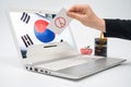 Online election concept. The hands of a male voter who casts a ballot on a laptop monitor Royalty Free Stock Photo