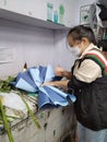 Shenzhen, China: The staff of an online fresh flower shop is binding flowers according to the order