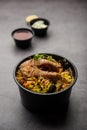 Online Food Delivery - Fish Pulao Or Biryani packed in Plastic box Royalty Free Stock Photo