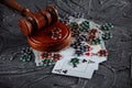 Online gambling and justice theme, cards, playing chips and judge gavel on old grey table