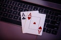 Online gambling theme. Aces on a laptop's keyboard Royalty Free Stock Photo