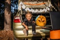 Online Halloween celebration. Kids scaring friends via internet at themed party in trunk of car