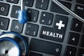 Online healthcare service concept with computer keyboard and stethoscope Royalty Free Stock Photo