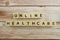 Online Healthcare word alphabet letters on wooden background