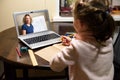 Online home education, tutor teaches preschool child during quarantine due to coronavirus. Kid learning with teacher by laptop