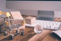 Online internet global purchases transportation business, cardboard boxes, trolley, earth globe on table with keyboard, mouse and Royalty Free Stock Photo