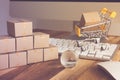 Online internet global purchases transportation business, cardboard boxes, trolley, earth globe on table with keyboard, mouse and Royalty Free Stock Photo