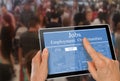 Online job hunting Hands with computer tablet reading employment ads infront of crowd of people Royalty Free Stock Photo