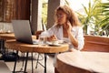 Online Job. Serious Girl Working With Laptop At Cafe Royalty Free Stock Photo