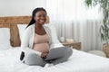 Online Jobs For Pregnant Women. Black Expectant Mother Using Laptop At Home