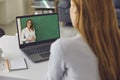 Online language school. Young woman watching English lesson on her laptop from home. Student participating in webinar Royalty Free Stock Photo