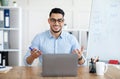 Online languages school. Arab male English teacher giving remote lesson on laptop computer at home office Royalty Free Stock Photo