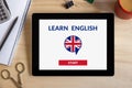 Online learn English concept on tablet screen with office object