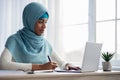 Online Learning Concept. Black Muslim Lady In Hijab Using Laptop At Home Royalty Free Stock Photo