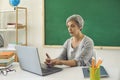 Online learning education. Female senior teacher is teaching students or schoolchildren using a video conference has a Royalty Free Stock Photo