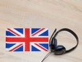 Internet learning of English. Top view of headphones and flag of Great Britain. Royalty Free Stock Photo