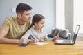 Online learning lessons education school. Father and daughter are doing online education with a teacher using a laptop Royalty Free Stock Photo
