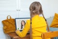 Online lesson. School shild girl using laptop at home