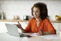 Online Lesson. Smiling Black Woman With Headset And Laptop Making Video Call Royalty Free Stock Photo