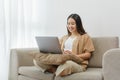 Online lifestyle concept A female home worker paying attention on the online meeting with her co-workers Royalty Free Stock Photo