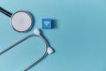 Online medicine. Online healthcare and medical consultation. Stethoscope, wooden cube with wifi sign on blue background