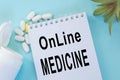 Online medicine-text inscription on a paper Notepad. News information, consultation, remote appointment with a specialist doctor