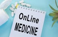 Online medicine-text inscription on a paper Notepad. News information, consultation, remote appointment with a specialist doctor