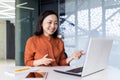 Online meeting video call young beautiful Asian woman working in modern office, businesswoman using laptop to Royalty Free Stock Photo
