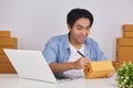 Online Merchant Writing Customer Address on Parcel or Package