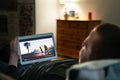 Online movie stream in tablet screen home at night. Man watching on demand film streaming service or music video. Tv series in VOD