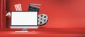 Online movie watching and cinematography concept with blank white modern computer monitor screen on empty red cinema background Royalty Free Stock Photo