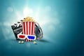 Online movies, cinemas, an image of popcorn, 3d glasses, a movie film and a blackboard on a blue background. The concept of a Royalty Free Stock Photo