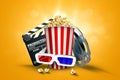 Online movies, cinemas, an image of popcorn, 3d glasses, a movie film and a blackboard on a yellow background. The concept of a Royalty Free Stock Photo