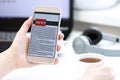 Online news on a mobile phone. Close up of businesswoman reading news or articles in a smartphone screen application. Royalty Free Stock Photo