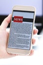 Online news on a mobile phone. Close up of businesswoman reading news or articles in a smartphone screen application. Royalty Free Stock Photo